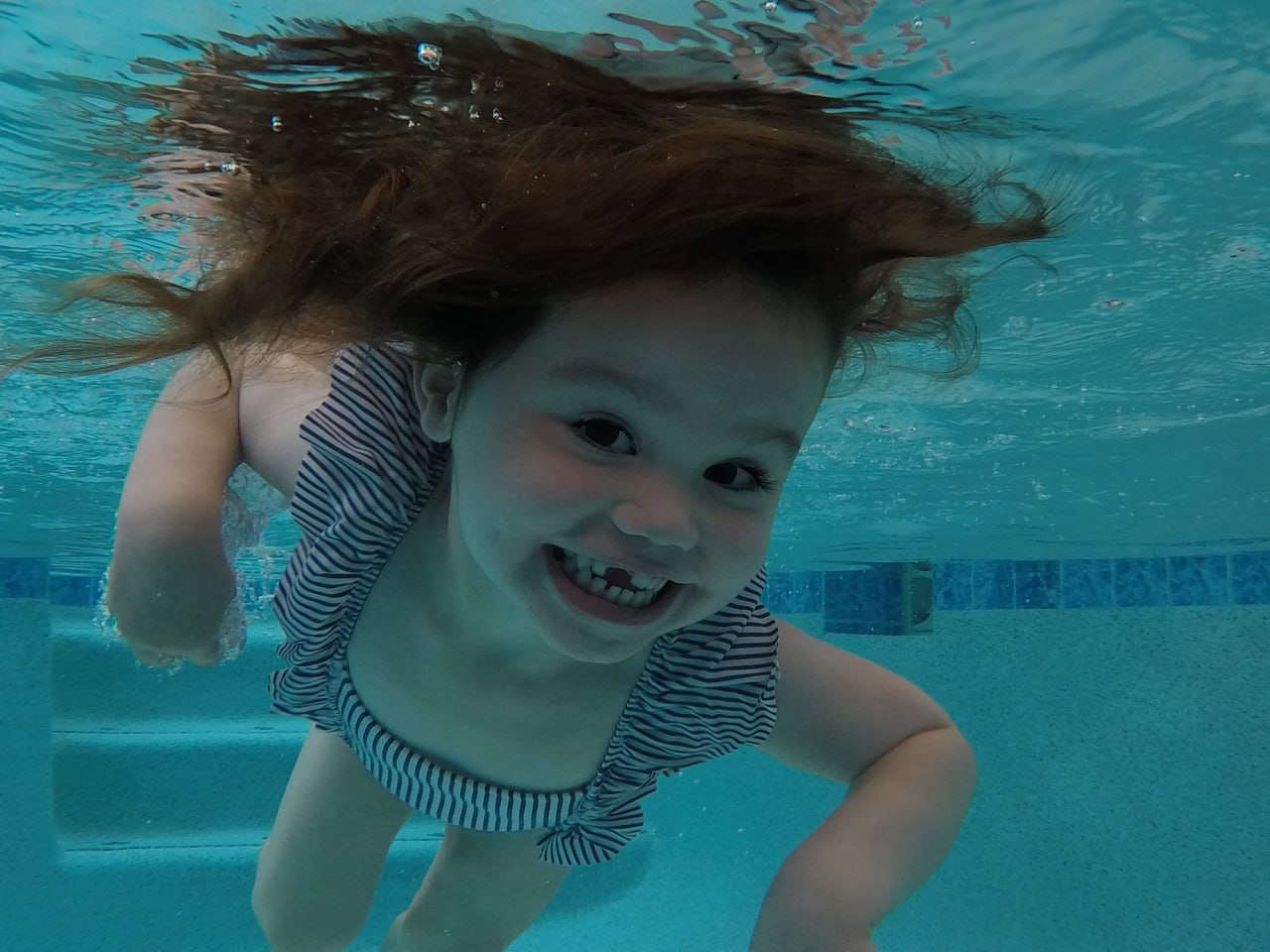 Child swimming underwater during ISR lesson