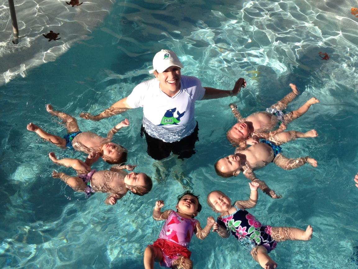 Girl in striped swimsuit practicing underwater skills