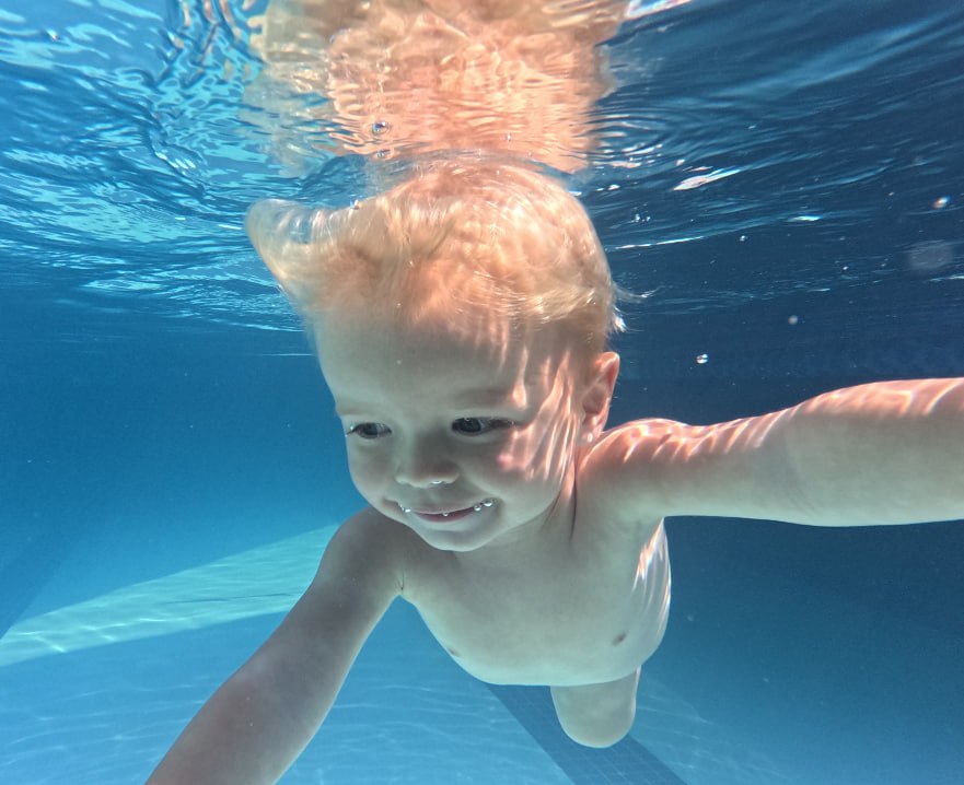 A boy swimming underwater during an ISR lesson